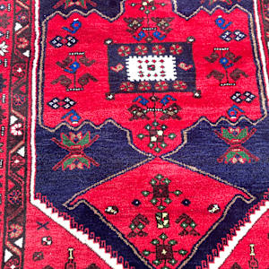 Vintage handmade wool rug red blue and cream center 