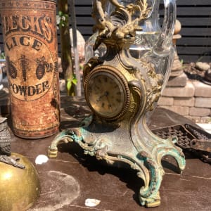Ornate metal clock with cherub