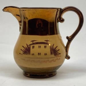 Copper luster pitcher with house 