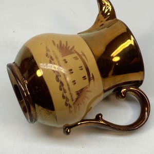 Copper luster pitcher with house