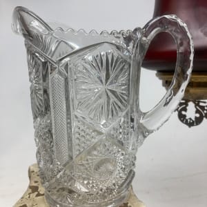 clear glass water pitcher with ornate pattern 