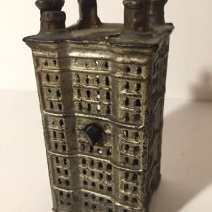 early iron penny bank in the shape of the Wrigley building 
