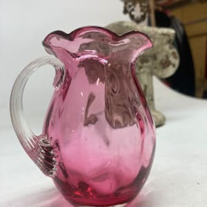 Small turn of the century cranberry glass creamer 