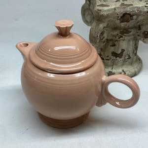 Peach colored Fiesta covered teapot 