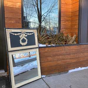 Carved Trudeau mirror 