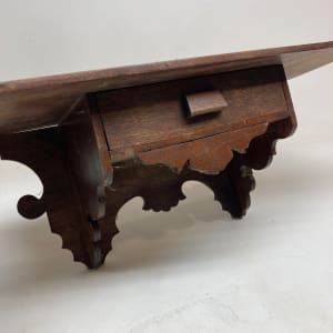 carved turn of the century shelf with drawer 