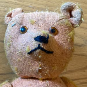 pink worn teddy bear 