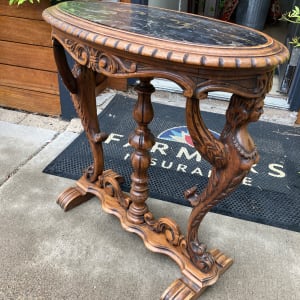 Carved marble top figural oval table 