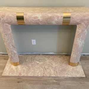 Pink marble post modern mantle with brass banding 