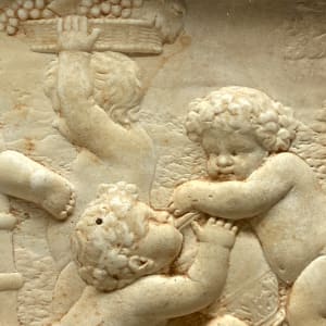 Framed relief of wine drinking cherubs 