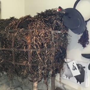 Kelp Sheep by BarbaraHouston ArtStudio  Image: Rinded black spruce legs, box frame, quilted strapping over mesh and kelp + eel grass, charred head/ears