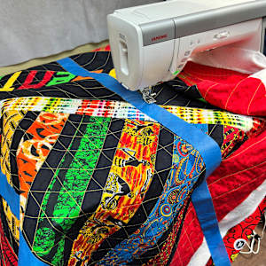 Celebrating the Beauty  of Freedom by O.V. Brantley  Image: Celebrating the Beauty of Freedom being quilted with tape