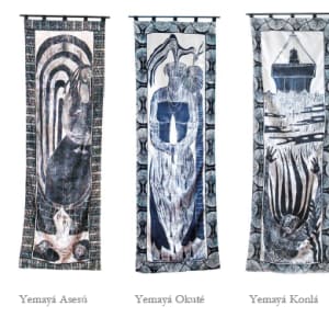 The Many Faces of Yemaya / Las Muchas Caras de Yemaya by Imna Arroyo  Image: The Seven Faces of Yemaya  101 long  33"  x 7 = 231"  wide
Woodblock prints on satin and framed with Batik fabric from Ghana
 98"x 33",  feet each
