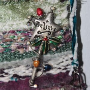 Believe Mini Fiber Art Tapestry by Annette  Image: Vintage metal pin plus tinkling bells and a dangling heart accent this unique multi yarn tapestry