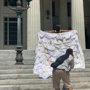 Arpillera Americanx * Cunt Quilt Surrender (Whitewall) Cunt Congress by Coralina Rodriguez Meyer  Image: Arpillera Americanx *Cunt Quilt (Whitewall) performance of Citizenship at the Miami Dade Courthouse in downtown Miami after a caravan honoring Supreme Court Justice Ruth Bader Ginsburg on September 28, 2020