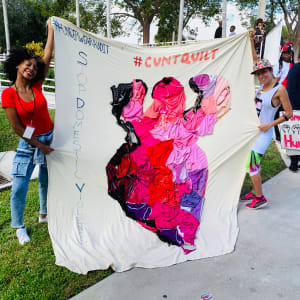 Arpillera Americanx * Cunt Quilt (Silueta) Cunt Congress by Coralina Rodriguez Meyer  Image: Griot-Doula Nicky Dawkins & Artist Coralina Rodriguez Meyer hold up the Arpillera Americanx * Cunt Quilt (Silueta) sanctuary city flag after Nicky's moving speech on reproductive justice in Florida. 
