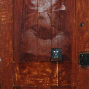 Access and Ambiguity (Door Project Installation) by Mark Gerard McKee  Image: Baba Vanga/Imna (verso), 2011, 76 ¾ x 29 x 2 ½”, Oil on door with small glass. (©2023, Mark Gerard McKee)