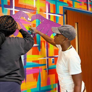 My Beautiful Dream for New Orleans by Young Artist Movement (YAM), Journey Allen  Image: Artist Journey Allen with YAM artists working on mural