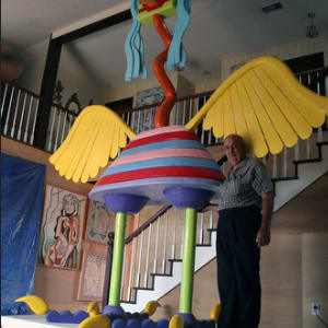 Zor Bird by James Robert Sohr  Image: In the center of his living room, towers a 29-ft. crane named the Zor Bird. Rising from the mud of Hurricane Katrina, the Dr. Seuss-like sculpture painted in primary colors was the prototype for a metal sculpture at the New Orleans Public Library's Children's Resource Center at the corner of Magazine Street and Napoleon Avenue.