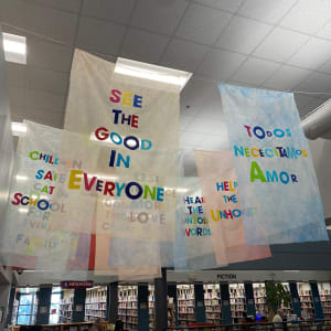 Our Wishes by Alejandra Abad  Image: "Our Wishes" by Alejandra Abad, 2022. Bemis Public Library main lobby (side view of first row of flags)