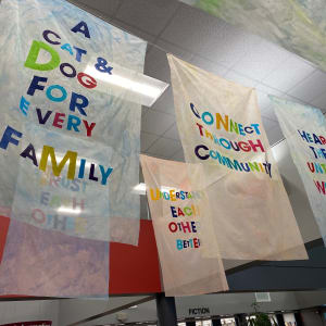 Our Wishes by Alejandra Abad  Image: "Our Wishes" by Alejandra Abad, 2022. Bemis Public Library main lobby (side view of third row of flags)