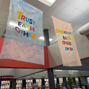Our Wishes by Alejandra Abad  Image: "Our Wishes" by Alejandra Abad, 2022. Bemis Public Library main lobby (side view of fourth row of flags)