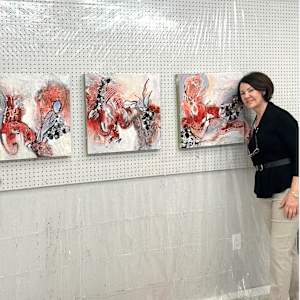 Coral Flow by Shirley Williams  Image: artist Shirley Williams in studio with Coral Flow triptych
