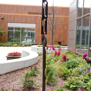 Totem-like rusted metal outdoor sculpture by Doris White