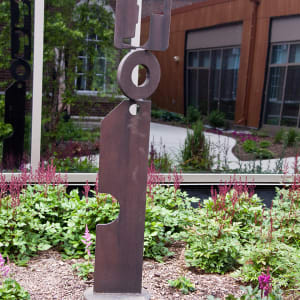 Totem-like rusted metal outdoor sculpture by Doris White 
