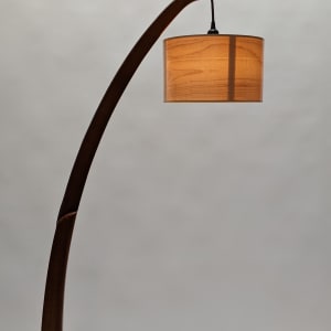 Snowdrop Floor Lamp by Tim Carney  Image: Tim's Snowdrop arched floor lamps with handmade-maple-veneer shades sold out almost as soon as we opened the CONTEMPORARY WOOD exhibit. We have gotten requests for special orders of these lamps, so Tim decided to make several more. These two are made of Sapele or Cherry. He will also entertain the notion of making one or more of these lamps in walnut, birch or maple. All will have his gorgeous maple-veneer lamp shade, an LED dimmable bulb and of course, the graceful form exactly like these. 
