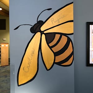 2025 Honeybee Mural by Frances Byrd  Image: Worker bee with sponsored dedications on wings
Approximately 3x4 feet
Located at ground level