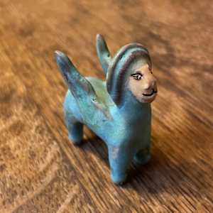 Blue Gem, a flying  teenie lion for truth and justice by Nell Eakin 