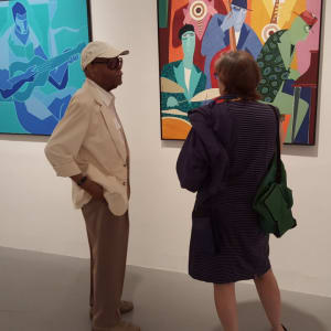 Music Maker by Joseph Lofton  Image: Joseph Lofton and gallerist Ellen Sragow, talking in front of The Savoy, Music Maker, Quintet and Burlesque at the 2015 Movement & Music show.
