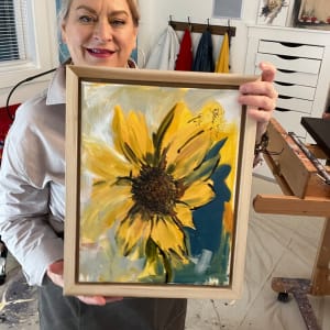 Sunflower with Blue by Carolyn Wonders  Image: A photo of that artist in her studio holding Sunflower with Blue