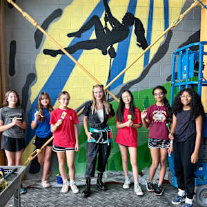 Chasing the Sun by American Academy  Image: American Academy Middle School Art Instructor, Chase Trout, along with seven of her gifted middle school students: Nethra, Avi, London, Addie, Mia, Millie, and Lyla. Collectively, they painted the mural, Chasing the Sun, near the Fieldhouse climbing wall.

The project was a collected effort between American Academy, the Public Art Commission, Parker Arts, and Parker Parks and Recreation.