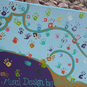 Lemon Gulch Trail Mural (Paint Parker Murals) by LDS Women's Conference  Image: Spanning an impressive 233 feet, this mural was designed by artist Janae Coy (pictured left of Cultural Director Carrie Glassburn), who incorporated themes of nature to represent the visual expression of neighborly love. After Coy outlined the design and color coded them by number, the mural came to life with the help of more than 175 women and girls from 13 congregations from The Church of Jesus Christ of Latter-Day Saints.
