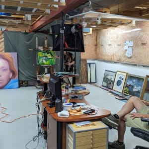 Lily Pads #3 by Richard Michael Delaney  Image: Delaney at his desk watching photographer Alexis Stewart at work documenting the paintings.