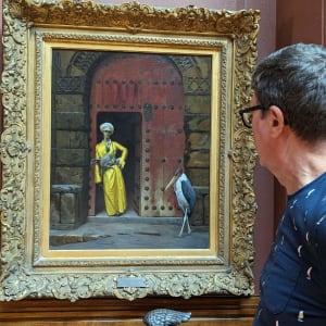 Seated Nude in Dorsal View by Richard Michael Delaney  Image: Delaney examines a painting by one of his favorite artists, Jean-Leon Gerome, at the Arnot Museum