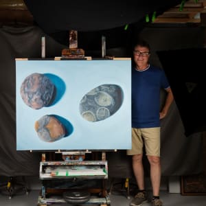 Three Stones on Blue by Richard Michael Delaney  Image: The artist with the painting turned on its side.