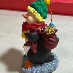 Penguin with package by David  H. L. Blackman, Ph. D. 