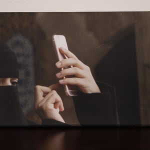 Covered Woman with iPhone, Istanbul by Helen Donis-Keller  Image: Front