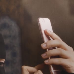 Covered Woman with iPhone, Istanbul by Helen Donis-Keller  Image: Close up