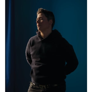 Self-portrait (blue room) by Jess Dugan