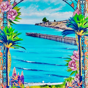 Vintage View by Cristina Sayers  Image: Village View features a colorful floral frame with a pier in the background, set against a vibrant sky. It captures an outdoor scene that includes elements like water, palm trees, and a beach landscape. The artwork is an analog collage created by the artist using original photographs and acrylic techniques to depict the view from entrance of Capitola Wharf.
