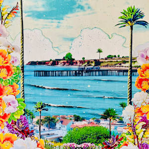 Depot Hill by Cristina Sayers  Image: 
The painting features a colorful floral frame with a pier in the background, set against a vibrant sky. It captures an outdoor scene that includes elements like water, palm trees, and a beach landscape. The artwork is an analog collage created by the artist using original photographs and acrylic techniques to depict the view from Depot Hill in Capitola Village.
