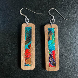 Wood Earrings with Canvas Inserts by Mark Johnston  Image: Single Pair of earrings, Custom painted Canvas, Walnut, Stirling Silver Ear Hooks and Jump Rings.