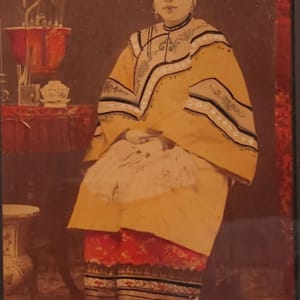 Chinese woman seated by table