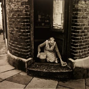 Shopkeeper Washing Doorstep, 1963 by Colin Jones