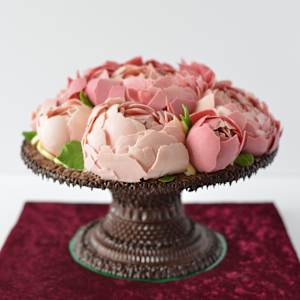 Chocolate artwork "Peony flowers" by Gerhard Petzl  Image: Peony flowers arrangement on baroque stand, 100% chocolate, on red velvet board