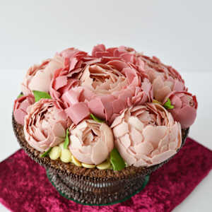 Chocolate artwork "Peony flowers" by Gerhard Petzl  Image: Peony flowers arrangement on baroque stand, 100% chocolate, on red velvet board